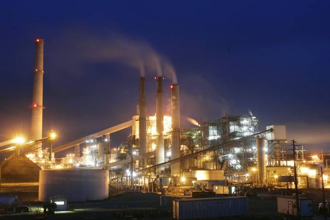 The coal-fired Reid Gardner Generating Station near Moapa is shown April 5, 2007. The spots near the smokestacks are "ghost" reflections of the lights on the plant, which can occur in digital cameras while shooting a point light source.   